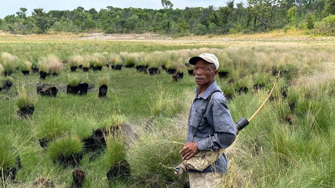 a man with a cap standing in a field